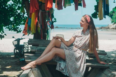 the concept of rest, travel - a beautiful girl sunbathing. Tourist on the island. decoration in the shape of a crossの写真素材