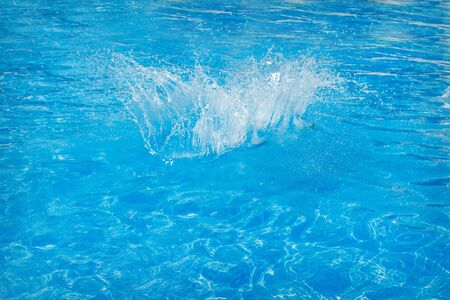 splashes of blue water in the pool close-up. copy spaceの写真素材