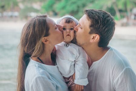 family holiday by the sea: man, woman and child on the beach. concept of travelの写真素材