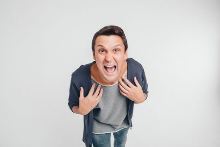 portrait of a man who screams. Isolated on white background. concept of freedom of expression of feelings, emotions, hysterics, anger, indignationの写真素材