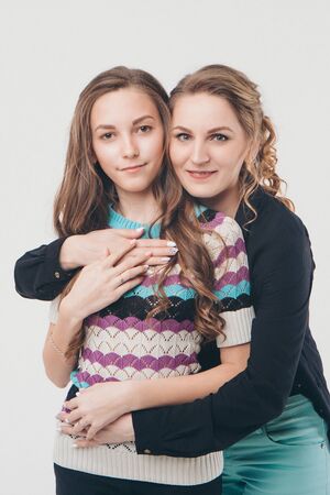 two happy girls smiling. Portrait of women hugging. The concept of relationships in the family, friends, sisters, couple in loveの写真素材