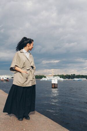 beautiful Asian woman with hair in Japanese style and kimono walking on the waterfrontの写真素材