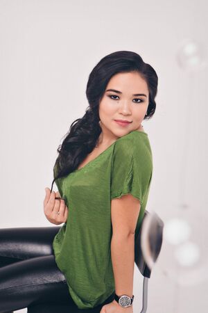 isolated photo: beautiful model with long hair shows off clothes. the concept of modeling business, is casual clothesの写真素材