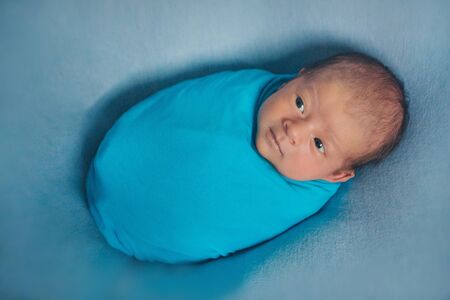 newborn baby sleeps wrapped in a blanket. concept of childhood, healthcare, IVF