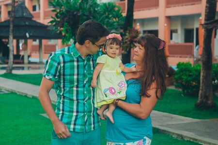 family holiday by the sea: man, woman and child on the beach. concept of travelの写真素材