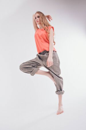 isolated photo: beautiful model with long hair shows off clothes. the concept of modeling business, is casual clothesの写真素材