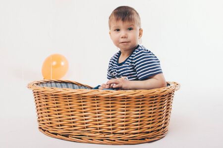 the concept of celebration, fun time spending - children in the basket on a white background among...