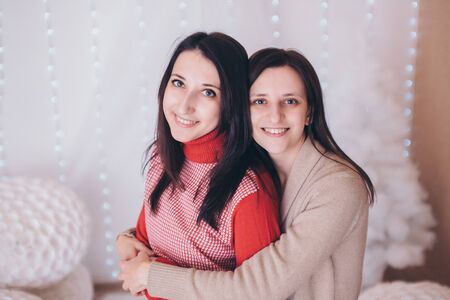 two happy girls smiling. Portrait of women hugging. The concept of relationships in the family, friends, sisters, couple in loveの写真素材
