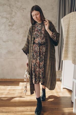 beautiful caucasian woman in Japanese kimono and black shoes on the background of the home interior. Model advertising clothesの写真素材