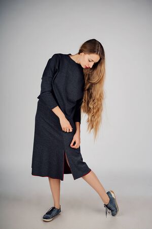 isolated photo: beautiful model with long hair shows off clothes. the concept of modeling business, is casual clothesの写真素材