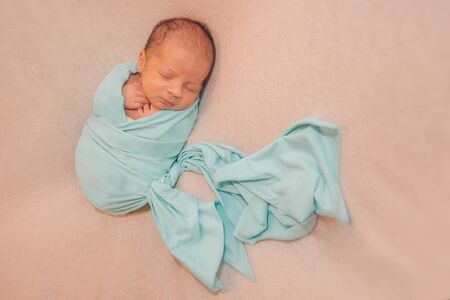 newborn baby sleeps wrapped in a blanket. concept of childhood, healthcare, IVFの写真素材