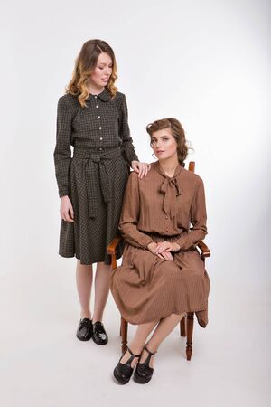 advertising of fashion for woman: dress, shoes. two happy girls smiling. Portrait of women hugging. The concept of relationships in the family, friends, sisters, couple in love.の写真素材