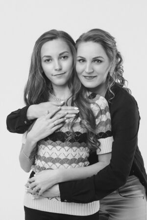 two happy girls smiling. Portrait of women hugging. The concept of relationships in the family, friends, sisters, couple in loveの写真素材