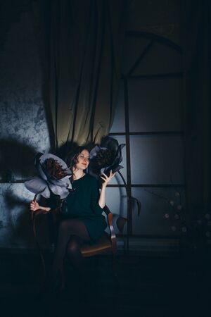 beautiful girl among the flowers and lantern in the shade. Spring mood-a woman in a fairy-tale worldの写真素材