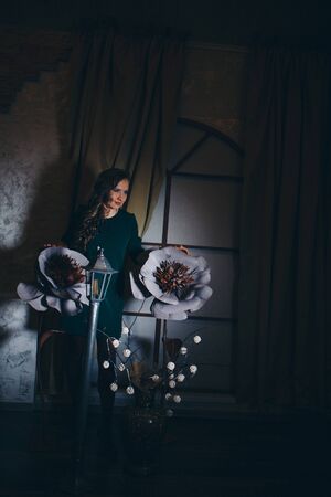 beautiful girl among the flowers and lantern in the shade. Spring mood-a woman in a fairy-tale worldの写真素材