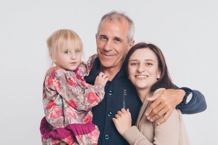 family photo on a white background: parents spend time with their children. mom and dad hug the baby. the concept of childhood, fatherhood, motherhood, IVFの写真素材