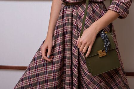 advertising women's fashion: dress, suit. female hand, bag and sleeve closeup. The ornament of clothing, seams, stitchinの写真素材