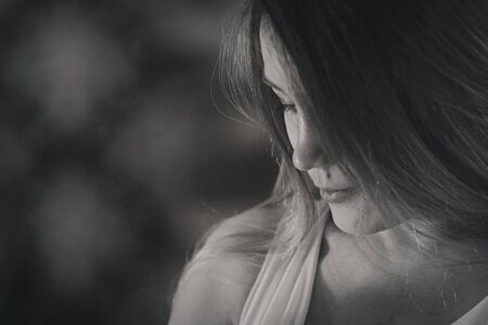 portrait of a woman in profile. Face covered with hair. Skin care concept, natural cosmeticsの写真素材