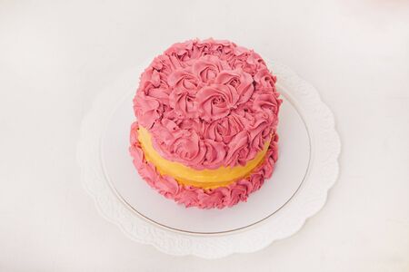 cake on white background closeup. Confectionery decorated with roses. The concept of advertising baking, calorie, food, dietの写真素材