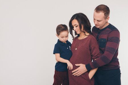 family photo on a white background: parents spend time with their children. mom and dad hug the...