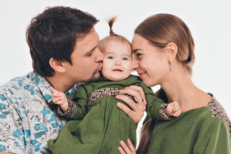 family photo on a white background: parents spend time with their children. mom and dad hug the baby. the concept of childhood, fatherhood, motherhood, IVFの写真素材