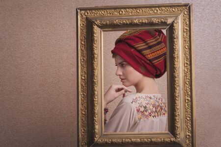beautiful sweet girl in turban in frame. Copy space. The concept of empty space for advertising,...