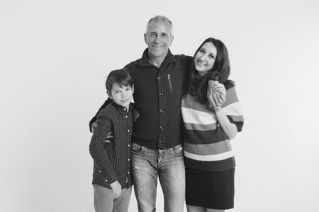 family photo on a white background: parents spend time with their children. mom and dad hug the baby. the concept of childhood, fatherhood, motherhood, IVFの写真素材