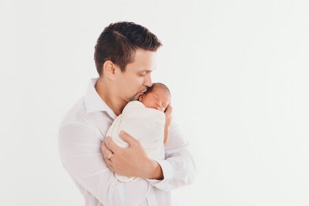 Dad holds the baby in his arms. The concept of educating the father of young children, Happy...