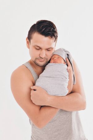 Dad holds the baby in his arms. The concept of educating the father of young children, Happy...