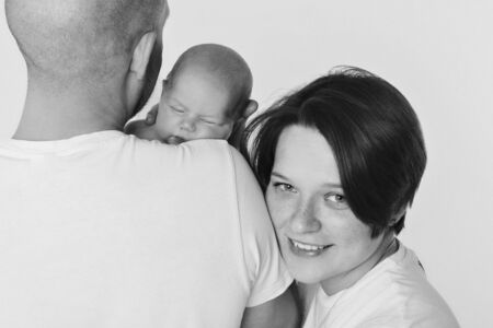 family photo on a white background: parents spend time with their children. mom and dad hug the baby. the concept of childhood, fatherhood, motherhood, IVFの写真素材