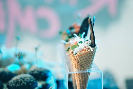Ice cream in a waffle cone with chocolate. Advertising concept of desserts, sweets, cooking, holidaysの写真素材