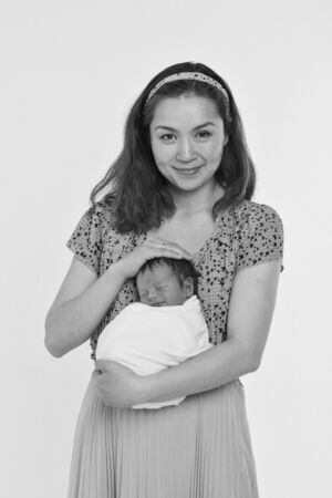 the concept of a healthy lifestyle, the protection of children, shopping - baby in the arms of the mother. Woman holding a child. Isolated on white background. Copy spaceの写真素材