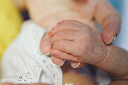 Baby's hand, fingers close up. newborn baby arms, massage concept of childhood, health care, IVF, hygieneの写真素材
