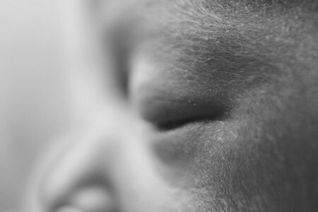 newborn baby's face close up: eyes, nose, lips. concept of childhood, health care, IVF, hygiene, ENTの写真素材