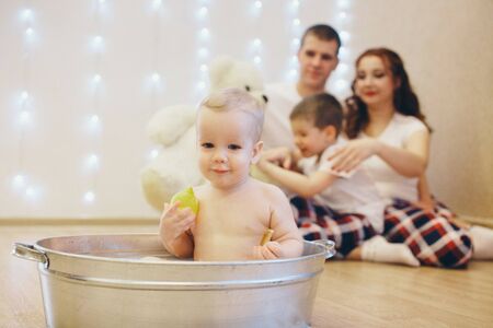 A little girl is bathing in a bath. A child washes in a basin s. concept of childhood, health care,...