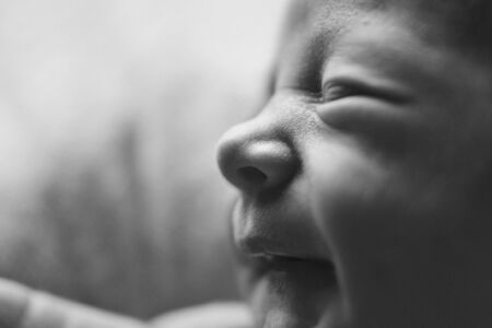 newborn baby's face close up: eyes, nose, lips. concept of childhood, health care, IVF, hygiene, ENT