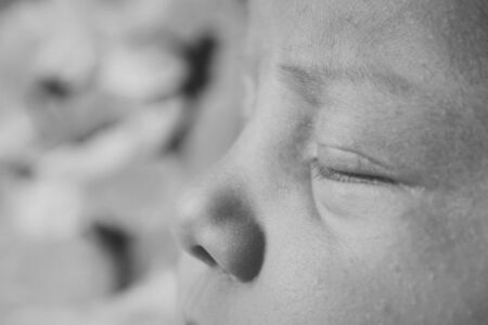 newborn baby's face close up: eyes, nose, lips. concept of childhood, health care, IVF, hygiene, ENTの写真素材