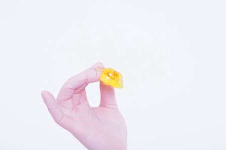 wax for depilation close-up. The girl demonstrates a cosmetic product. The doctor's gloved hand....