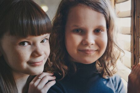 girl by the window. child looking out. Concept oflife style, holidaysの写真素材