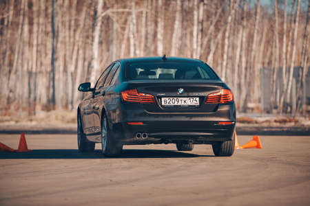 BMW advertising, Moscow, 1.11.2018: demonstration of a model of a black car, cars on a test track,...