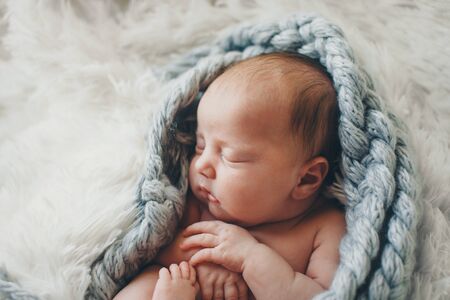portrait of a little girl in a wool blanket. imitation of the umbilical cord, a baby in the womb....