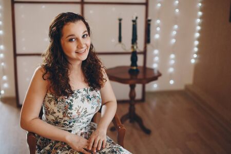 the girl is sitting on the chairs. spending time in self-isolation. interior decorationの写真素材