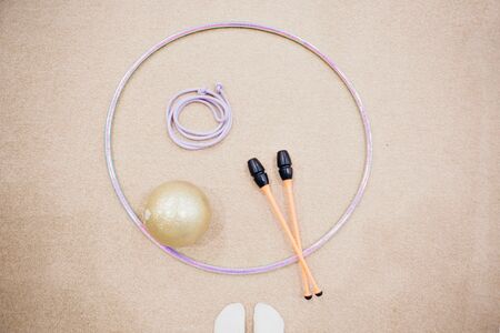 A variety of sports equipment: jump rope, Hoop, dumbbells on a white background. Top view of gym accessoriesの写真素材