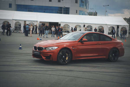 advertising BMW, Moscow, 1.11.2018: demonstration of the red car model, cars in the test track, dust from under the wheels, tracks on the road, race, driving training in a driving school, delivery around the city, taxiのeditorial素材