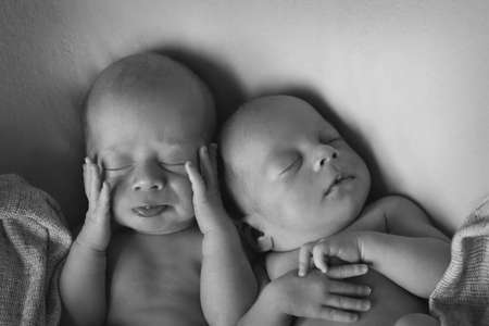 IVF results: The twins embrace. newborn babies sleep togetherの写真素材