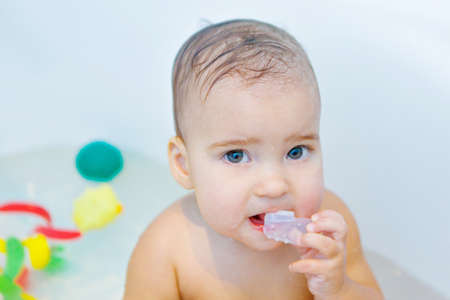 a little girl brushes her teeth in the bathroom. portrait of a child with a toothbrush