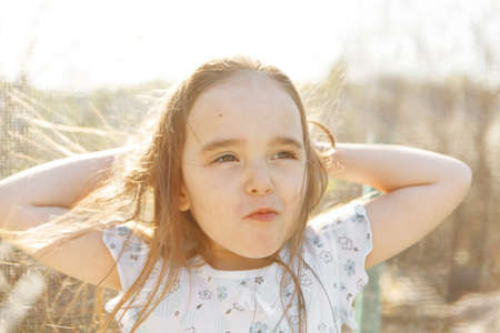 portrait of a girl with her hair down and blowing in the wind.hairstyle without antistatic. windy...