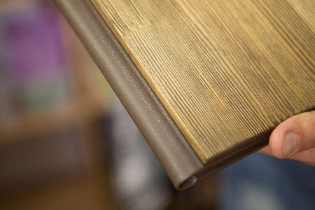 Diary close-up on a beige background. the cover is made of wood. the best gift - a photo album