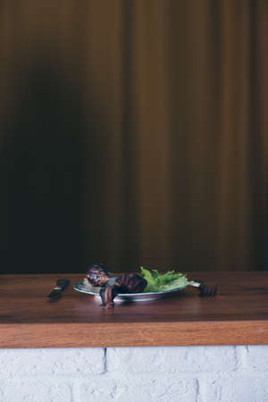 2 large snails close-up. Animals on a plate with salad and cucumber. Concept of French cuisine, delicacy, food, pet maintenance. the class of gastropods, mollusksの写真素材