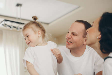 A family with child. Weekend at home. Spending time togetherの写真素材